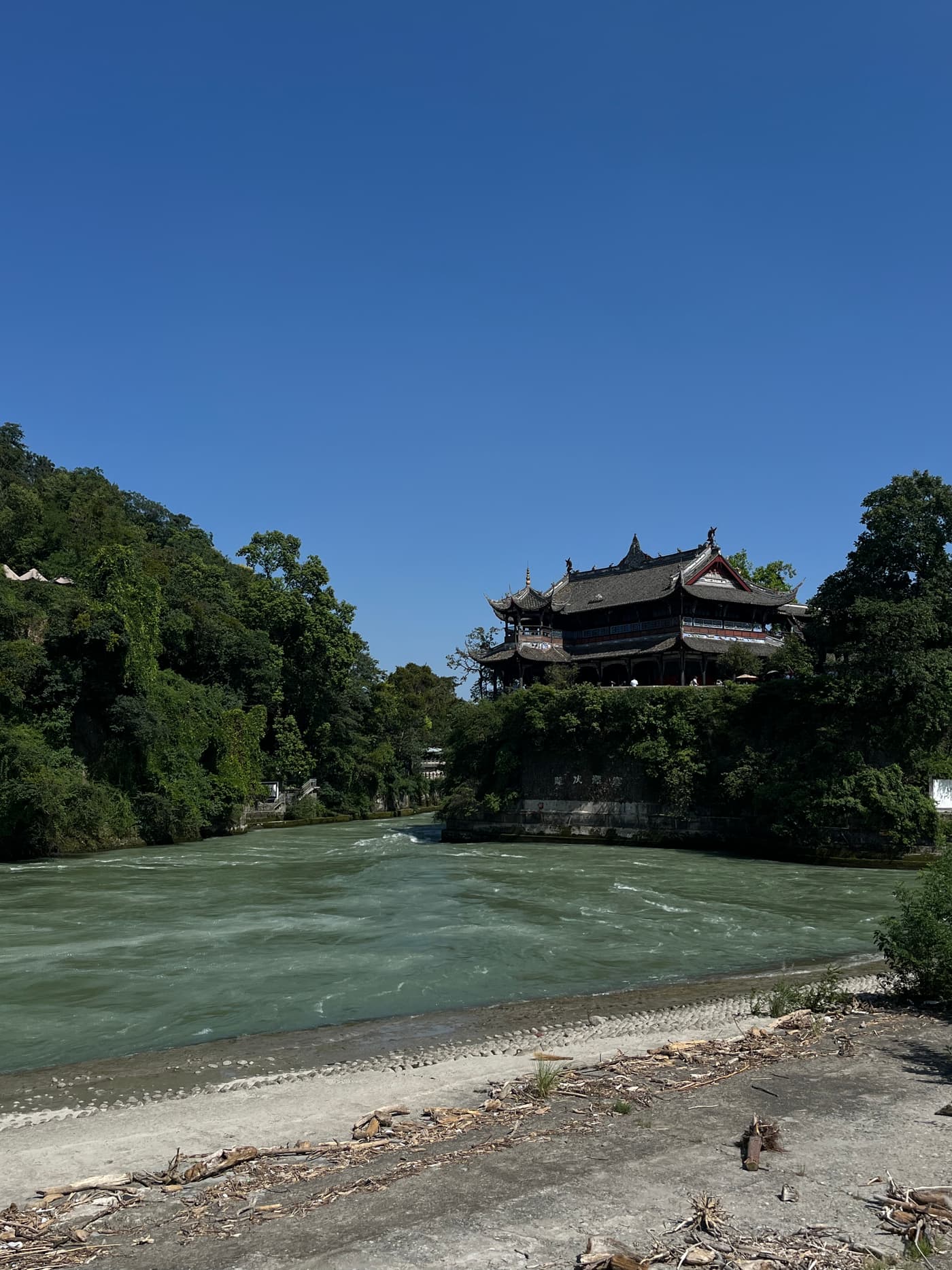 a pavilion above the min river at dujiangyan, sichuan, on a clear day
